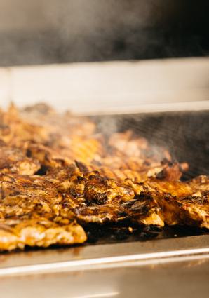Chicken being prepared on a grill