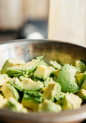 A bowl of cut up avacados